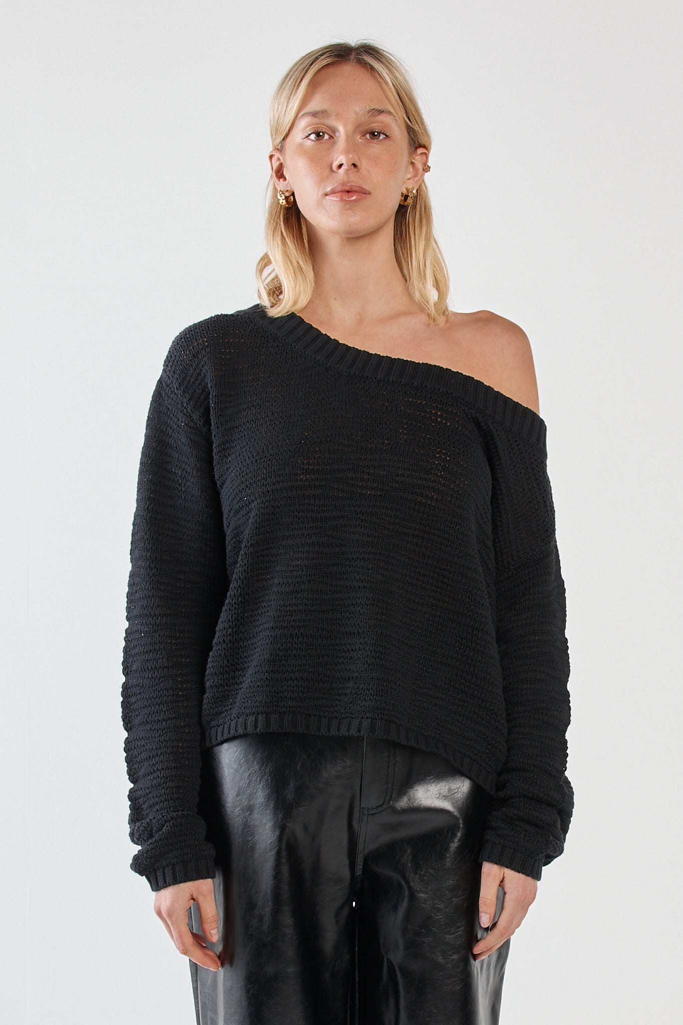 Image of a model wearing Outerwear. Product name - Kiara Asymmetric Knit Black in Black colour by brand - Sass Clothing