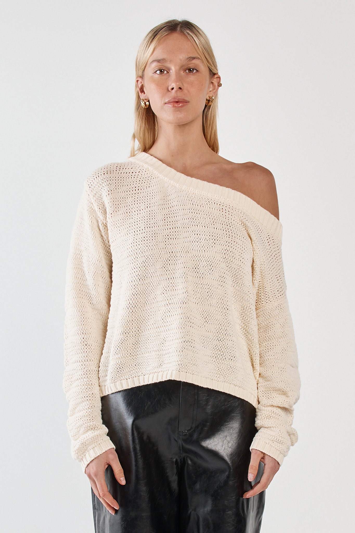 Image of a model wearing Outerwear. Product name - Kiara Asymmetric Knit Cream in Cream colour by brand - Sass Clothing
