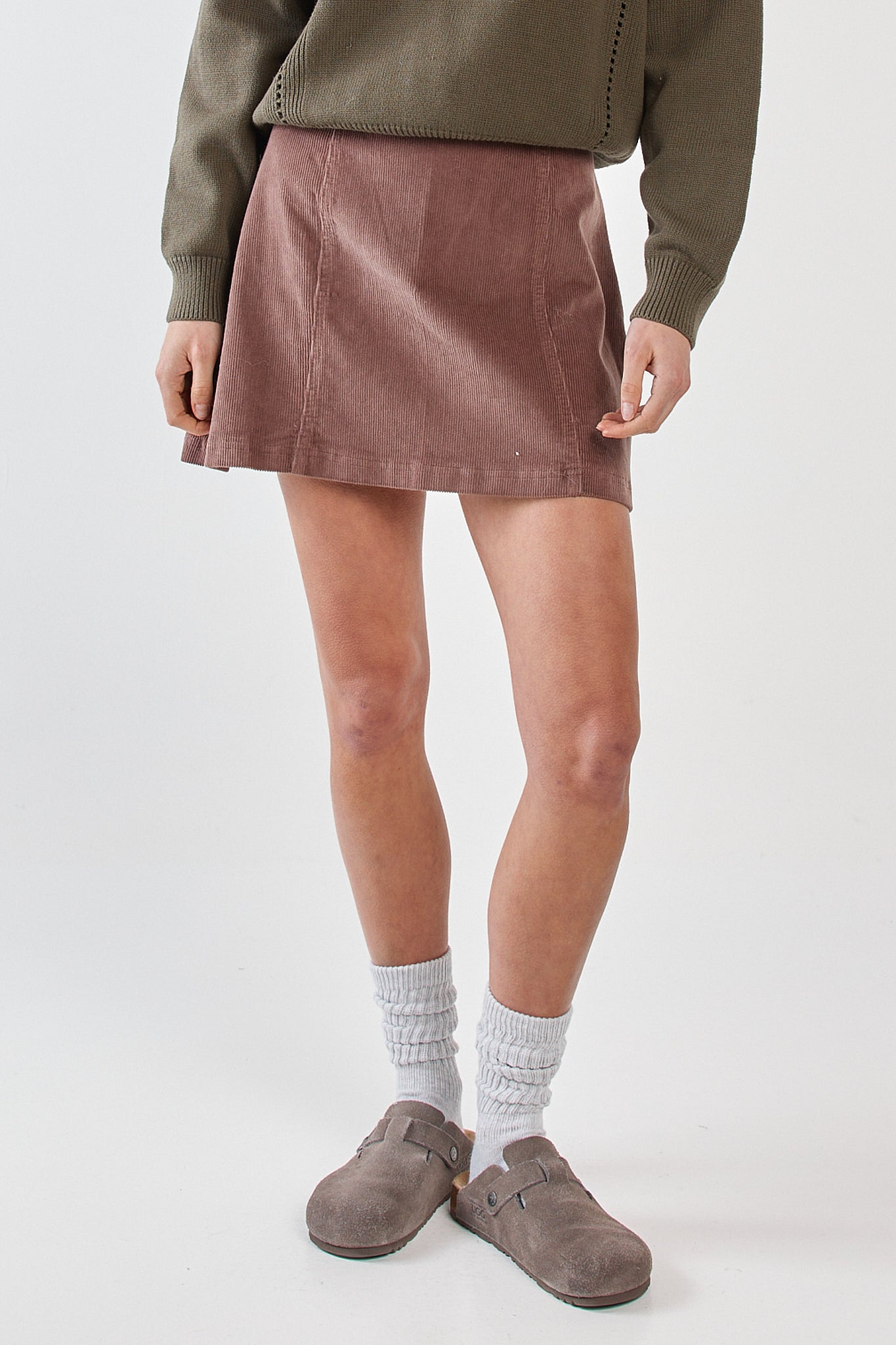 Image of a model wearing Skirts. Product name - Parco Cord Mini Skirt Mushroom in Mushroom colour by brand - Sass Clothing