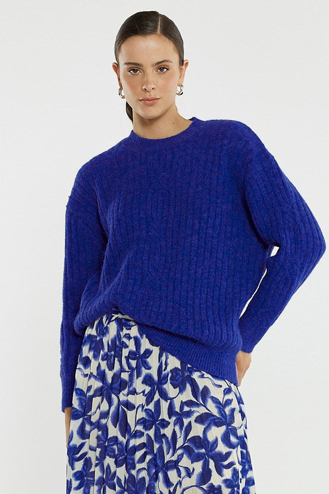 Image of a model wearing Outerwear. Product name - Kira Cable Jumper in Cobalt colour by brand - Sass Clothing
