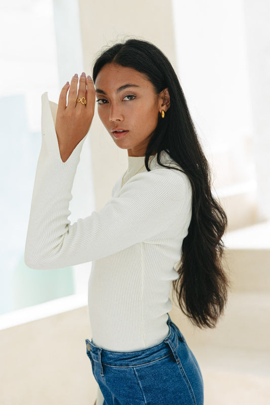 Image of a model wearing Tops. Productname: Heychic Vikki Long Sleeve Knit Top in Off-White colour by brand - Heychic