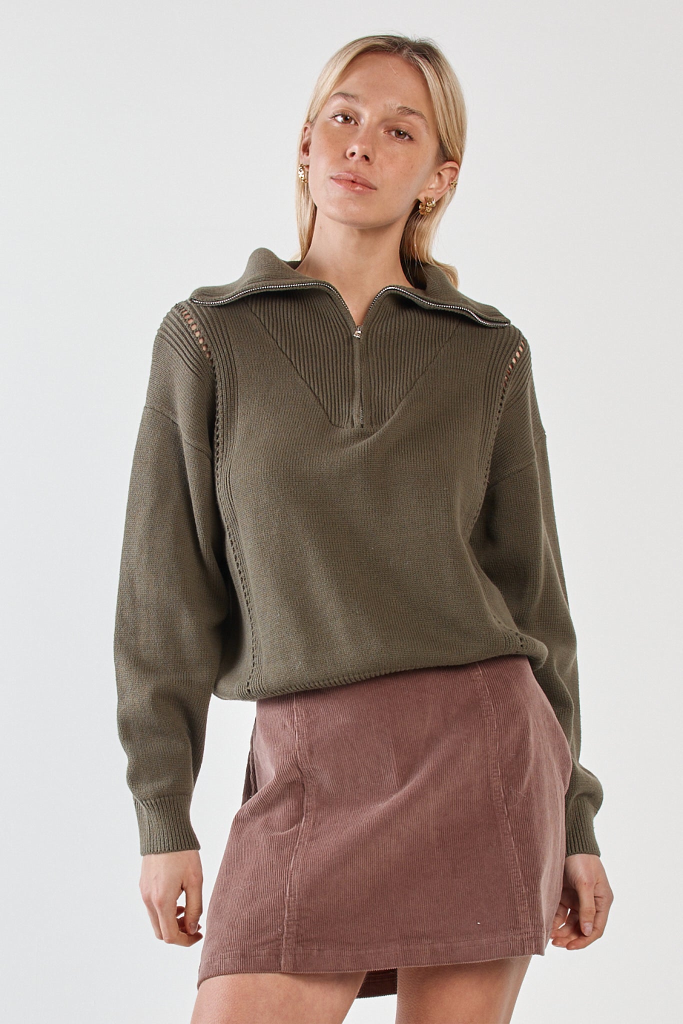 Image of a model wearing Tops. Product name - Esti Pointelle Zip Up Knit Khaki in Khaki colour by brand - Sass Clothing