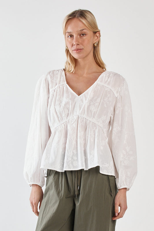 Image of a model wearing Tops. Product name - Lois Embroidered Piped Blouse White in White colour by brand - Sass Clothing