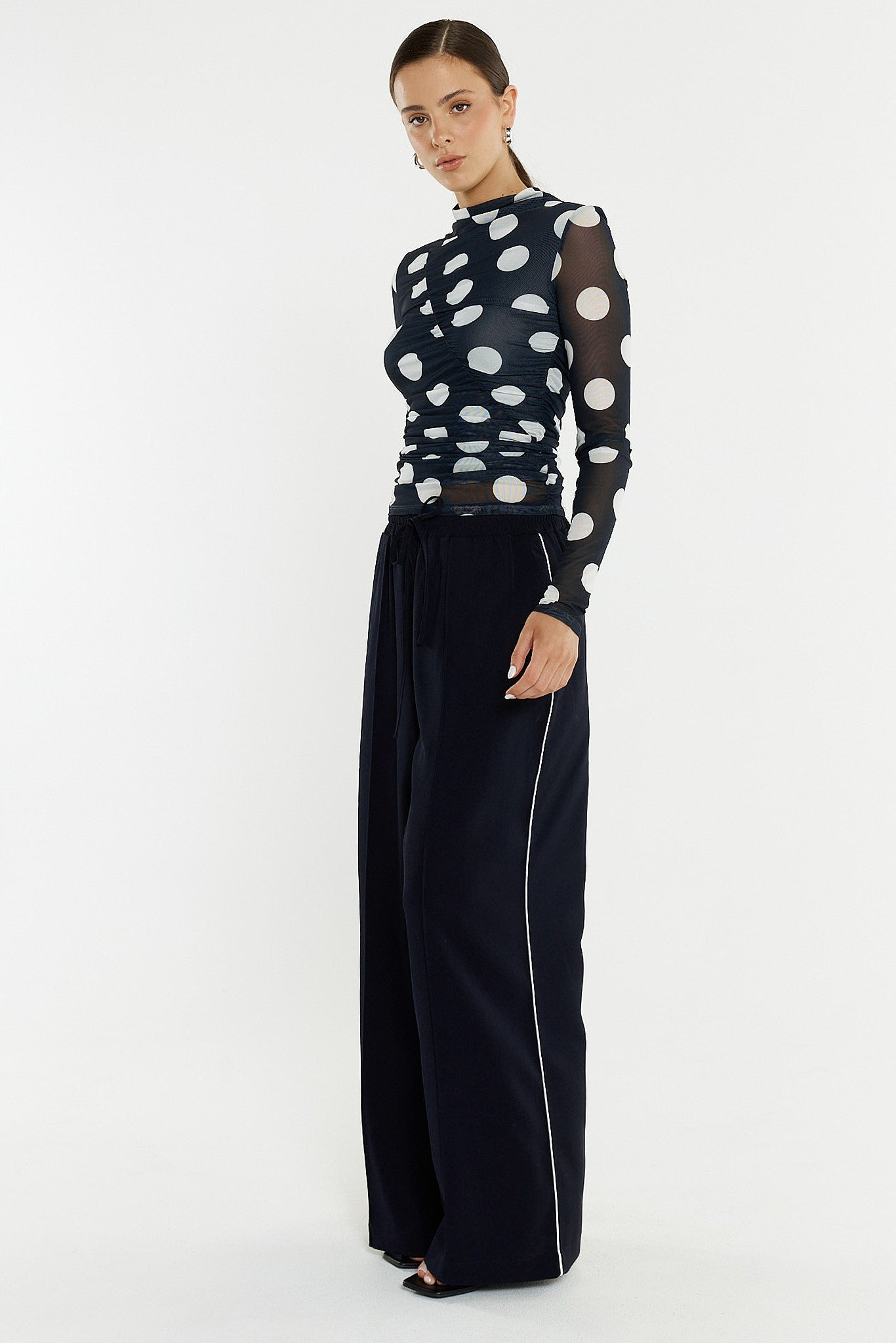Image of a model wearing Pants. Product name - Eva Side Seam Pant in Navy/Cream colour by brand - Sass Clothing
