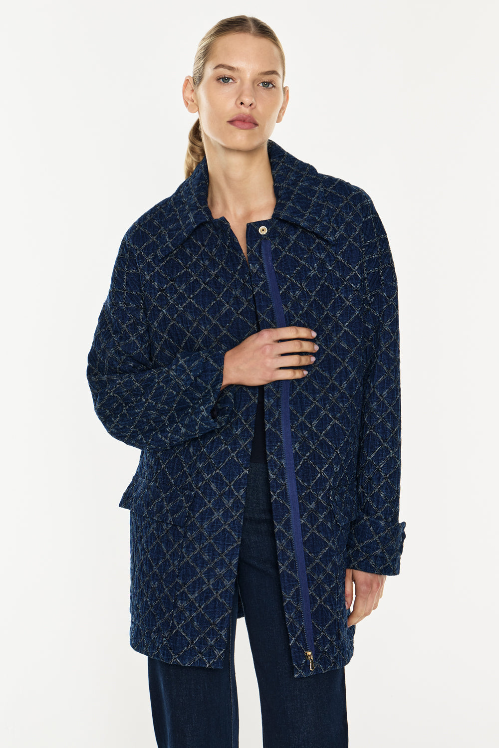 Image of a model wearing Outerwear. Productname: Quilted Denim Bomber in Blue colour by brand - Manning Cartell
