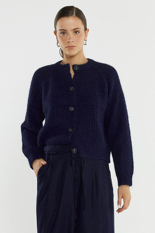 Image of a model wearing Outerwear. Product name - Posie Fluffy Cardi in Navy colour by brand - Sass Clothing