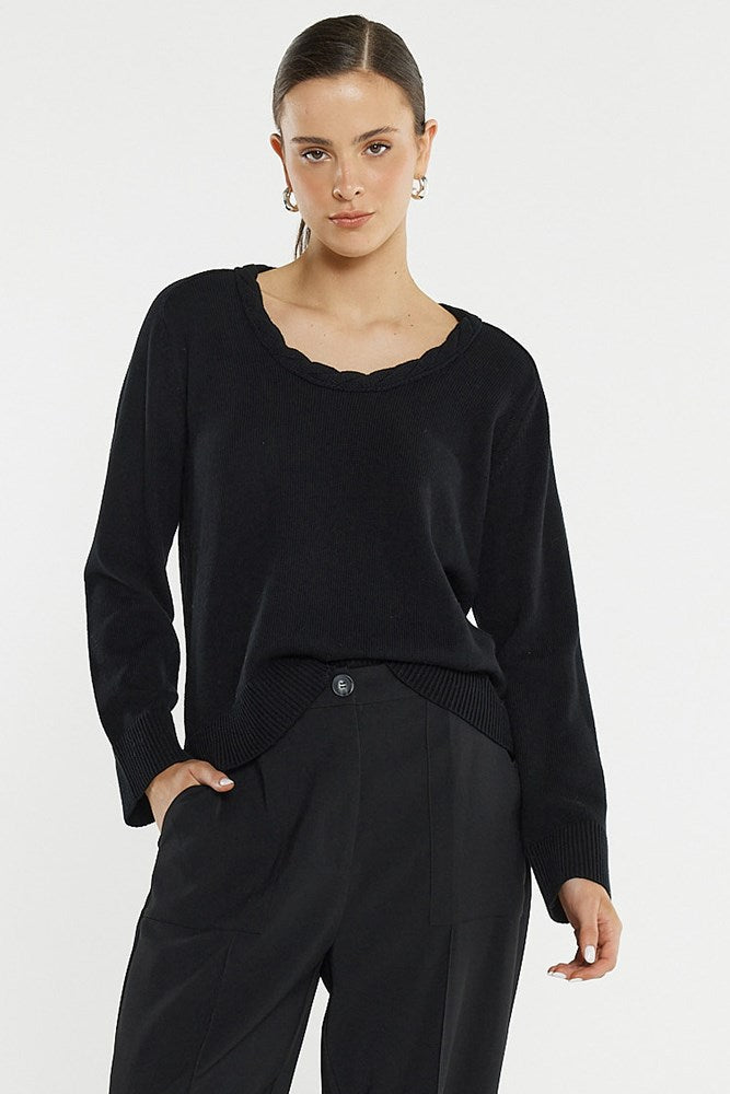 Image of a model wearing Outerwear. Product name - Roe Braided Neck Knit in Black colour by brand - Sass Clothing