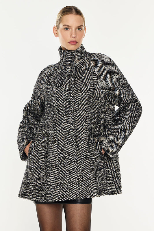 Image of a model wearing Outerwear. Productname: Time After Time Coat in Black/Stone colour by brand - Manning Cartell