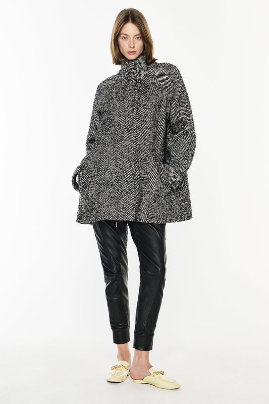 Image of a model wearing Outerwear. Productname: Time After Time Coat in Black/Stone colour by brand - Manning Cartell