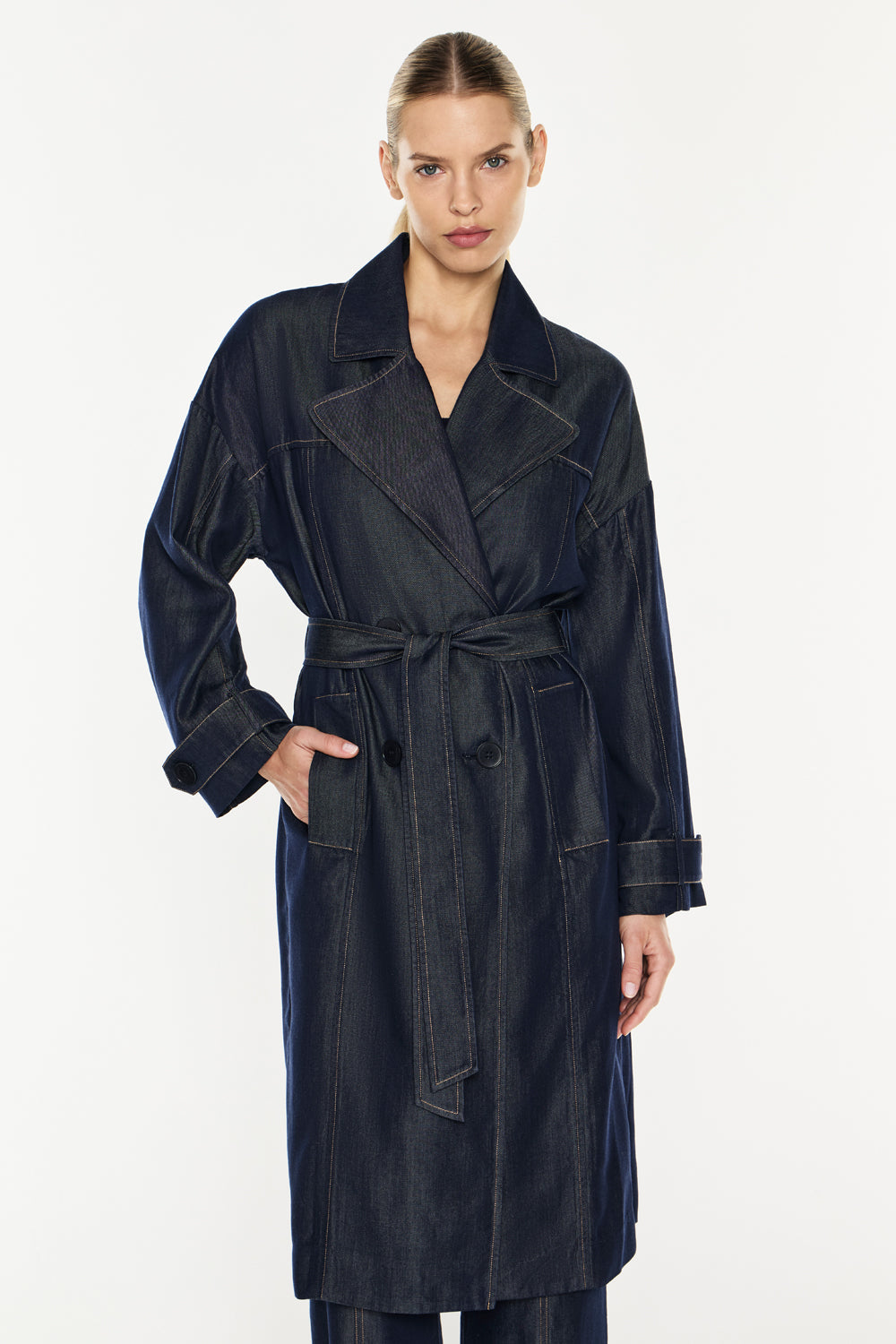 Image of a model wearing Outerwear. Productname: Quiet Command Trench in Indigo colour by brand - Manning Cartell