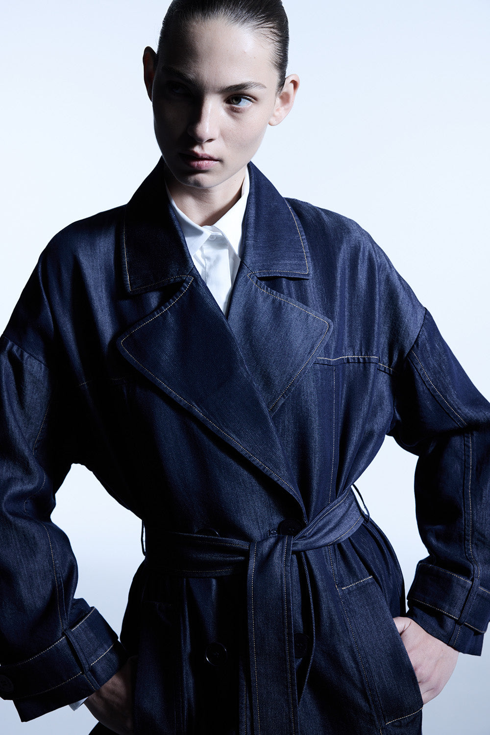 Image of a model wearing Outerwear. Productname: Quiet Command Trench in Indigo colour by brand - Manning Cartell