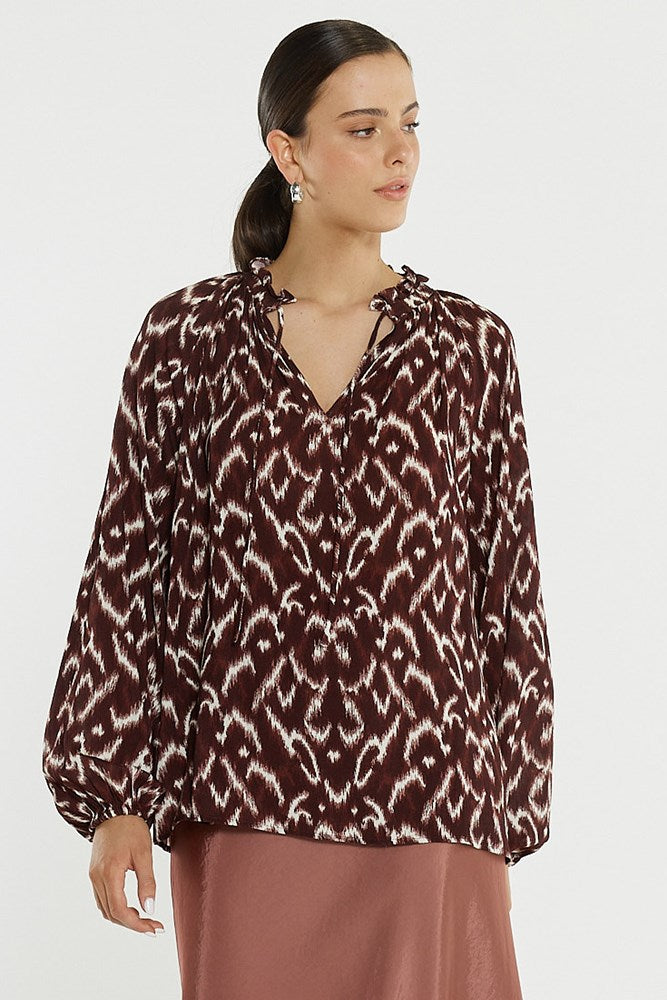 Image of a model wearing Tops. Product name - Willow Tie Front Blouse in Ikat colour by brand - Sass Clothing