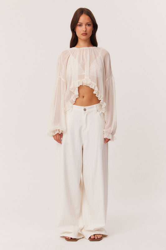 Image of a model wearing Outerwear. Productname: SNDYS LAURIE LONG SLEEVE TOP in Off White colour by brand - SNDYS