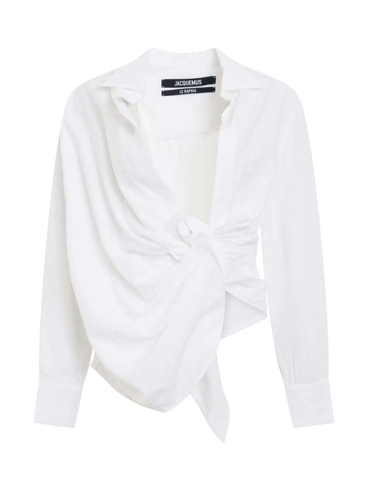 Image of a model wearing Tops. Productname: JACQUEMUS Bahia Tied Sash Shirt in White colour by brand - JACQUEMUS