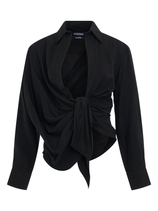 Image of a model wearing Tops. Productname: JACQUEMUS Bahia Tied Sash Shirt in Black colour by brand - JACQUEMUS