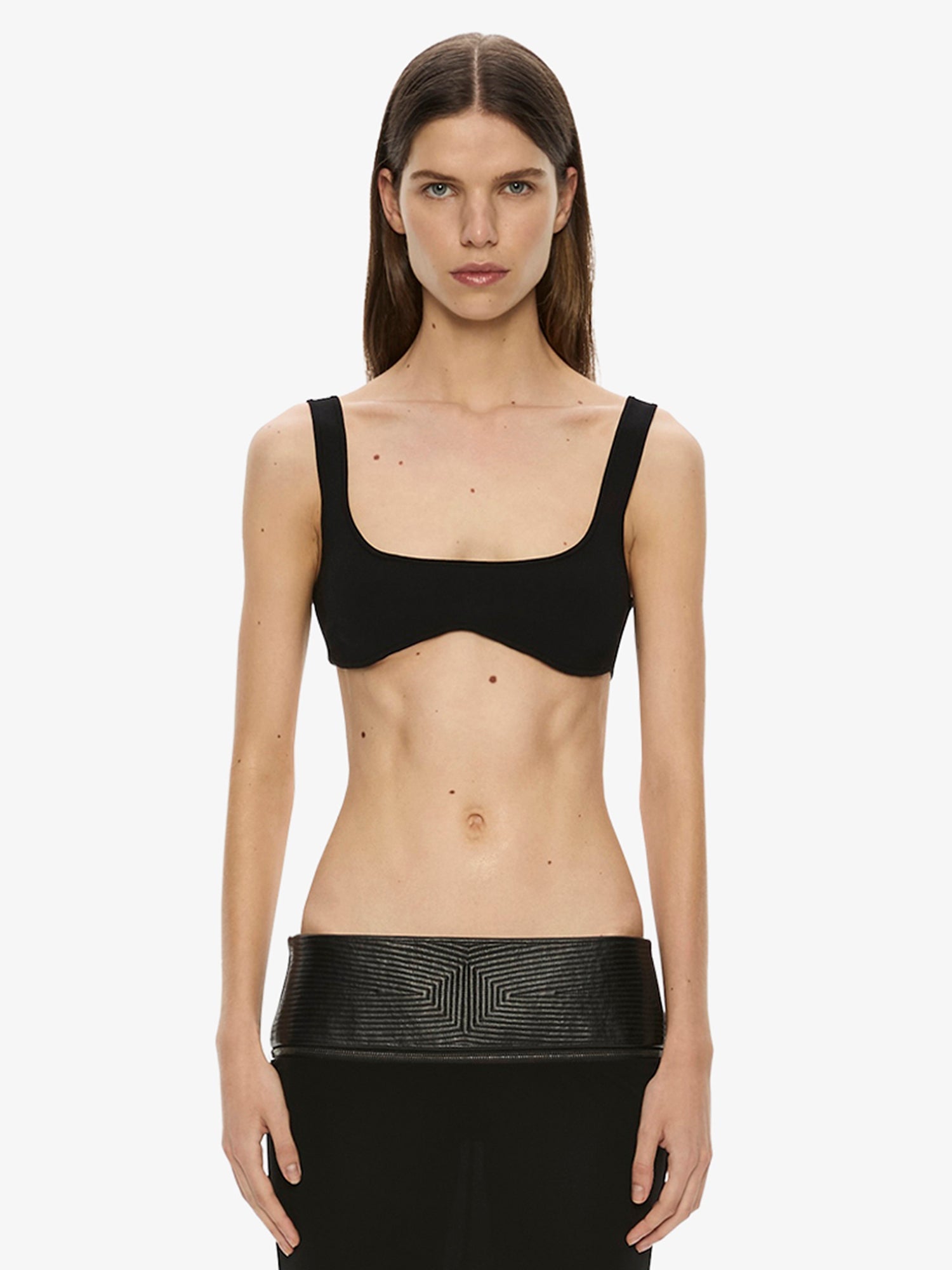 Image of a model wearing Tops. Product name - Mineta Knit Bra in Black colour by brand - Christopher Esber