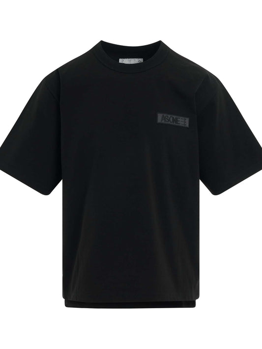 Image of a model wearing Tops. Productname: SACAI Eric Haze Patch T-Shirt in BLACK colour by brand - SACAI