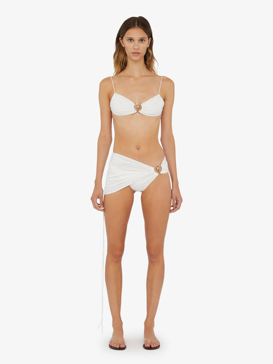 Image of a model wearing Skirts. Product name - Ruched Orbit Skirt Brief in White colour by brand - Christopher Esber