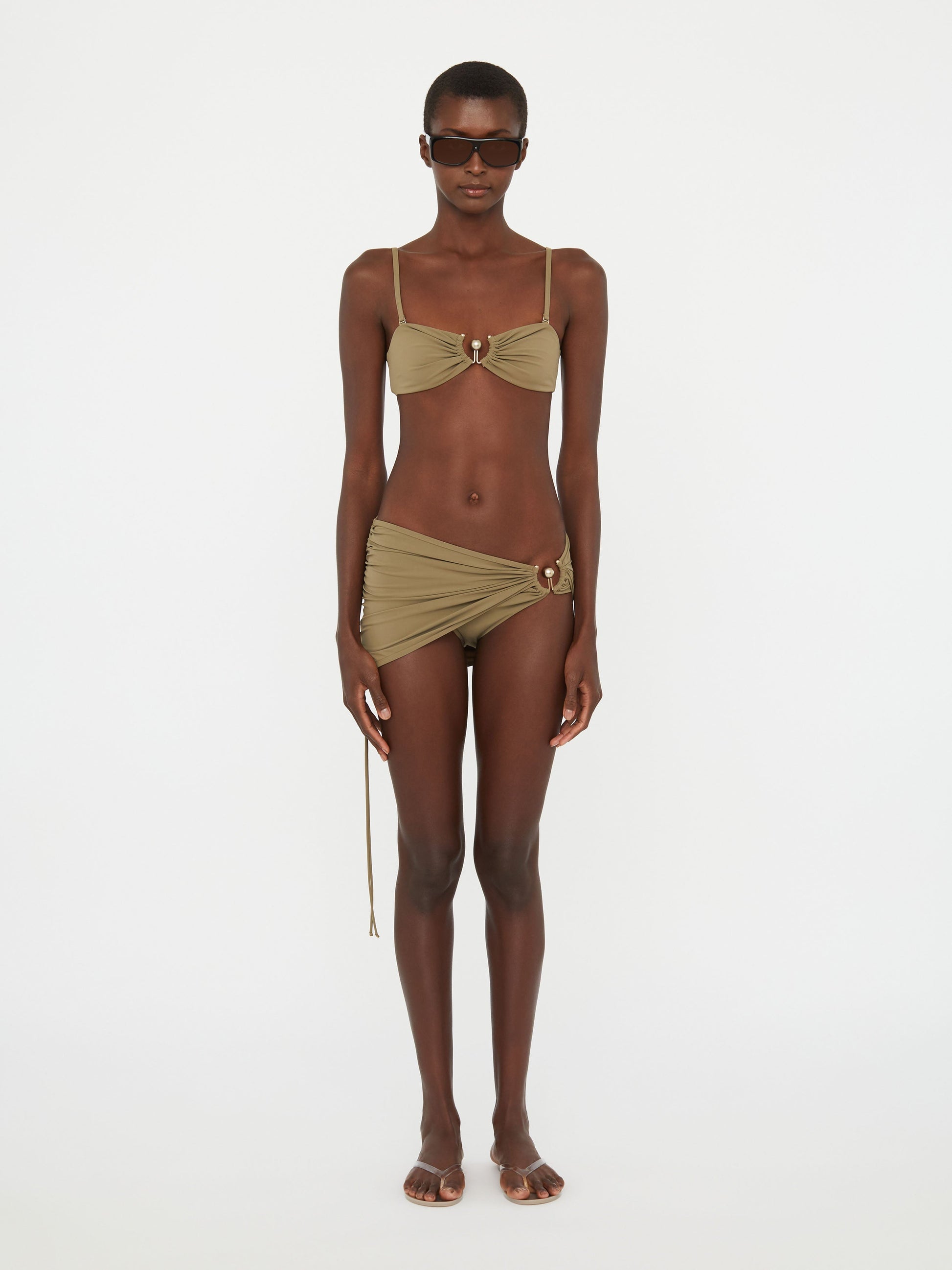 Image of a model wearing Skirts. Productname: Christopher Esber Ruched Orbit Skirt Brief in Eucalypt colour by brand - Christopher Esber