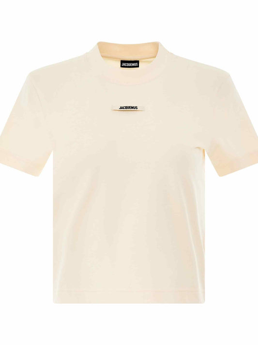 Image of a model wearing Tops. Productname: JACQUEMUS Gros Grain Logo T-Shirt in BEIGE colour by brand - JACQUEMUS