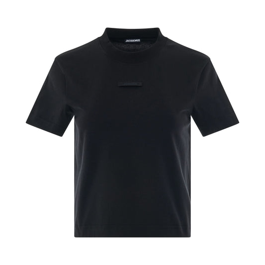 Image of a model wearing Tops. Productname: JACQUEMUS Gros Grain Logo T-Shirt in BLACK colour by brand - JACQUEMUS