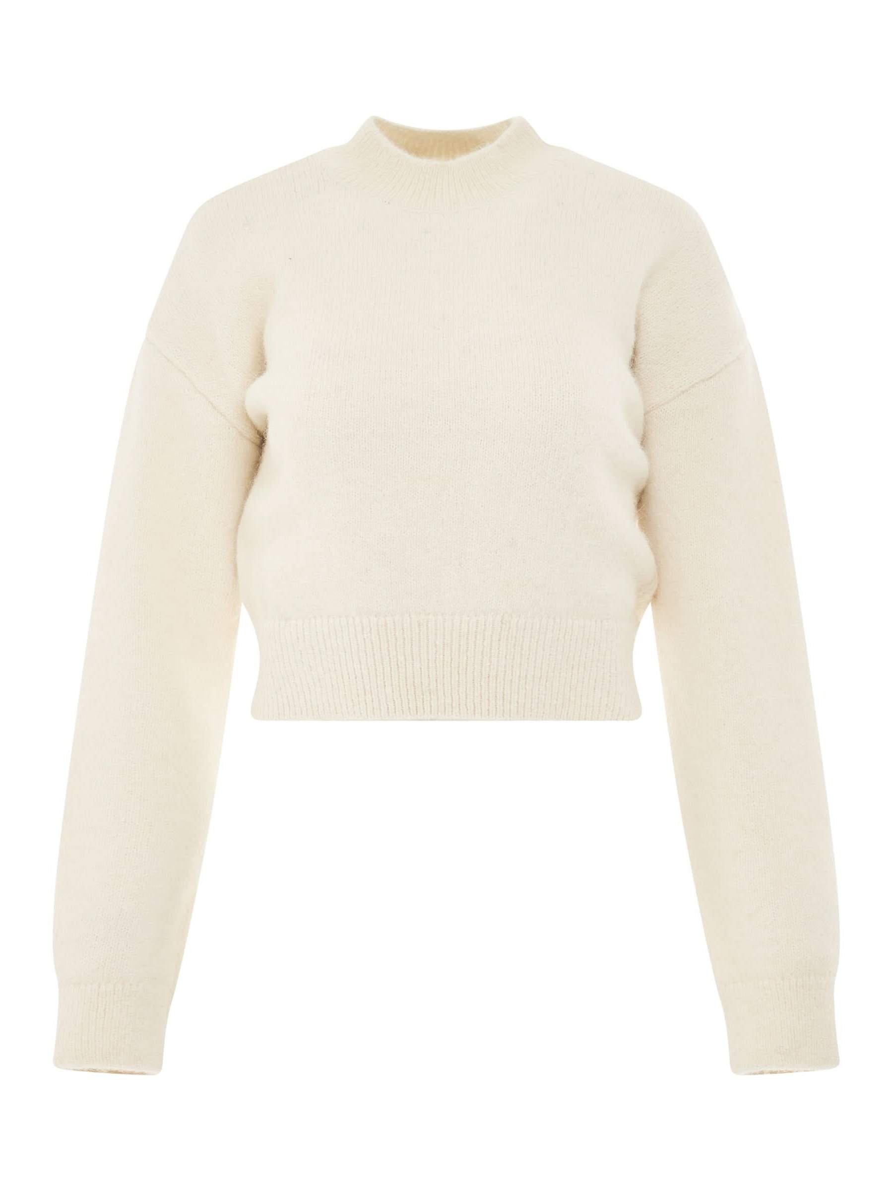Image of a model wearing Outerwear. Productname: JACQUEMUS La Maille Jacquemus Sweater in Light Beige colour by brand - JACQUEMUS