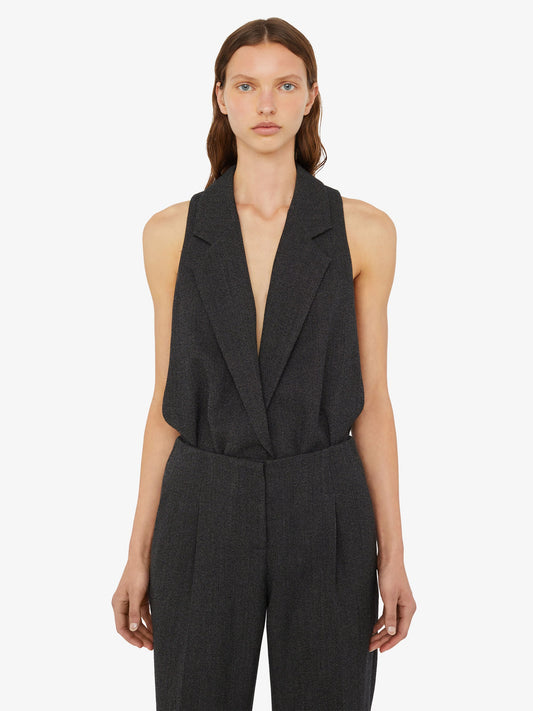 Image of a model wearing Tops. Product name - Facile Tailored Twill Bodysuit in Black colour by brand - Christopher Esber