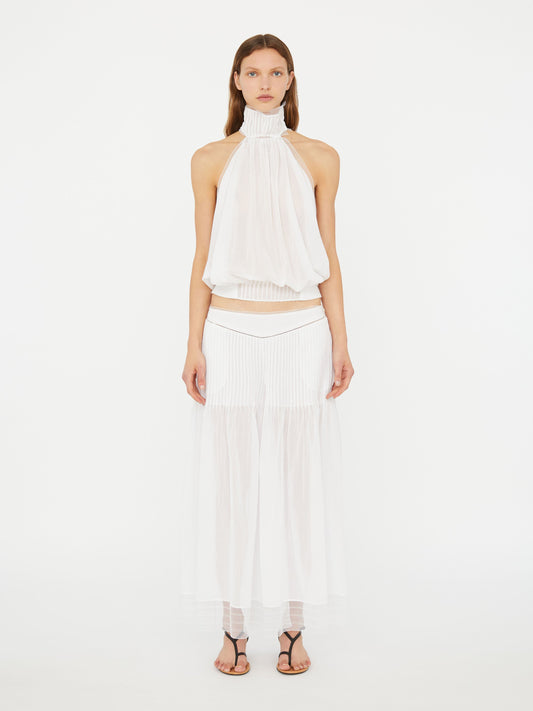 Image of a model wearing Pants. Product name - Vanished Pintucked Pant in White colour by brand - Christopher Esber