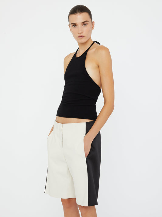 Image of a model wearing Tops. Product name - Cashmere Rae Halter Tank in Black colour by brand - Christopher Esber