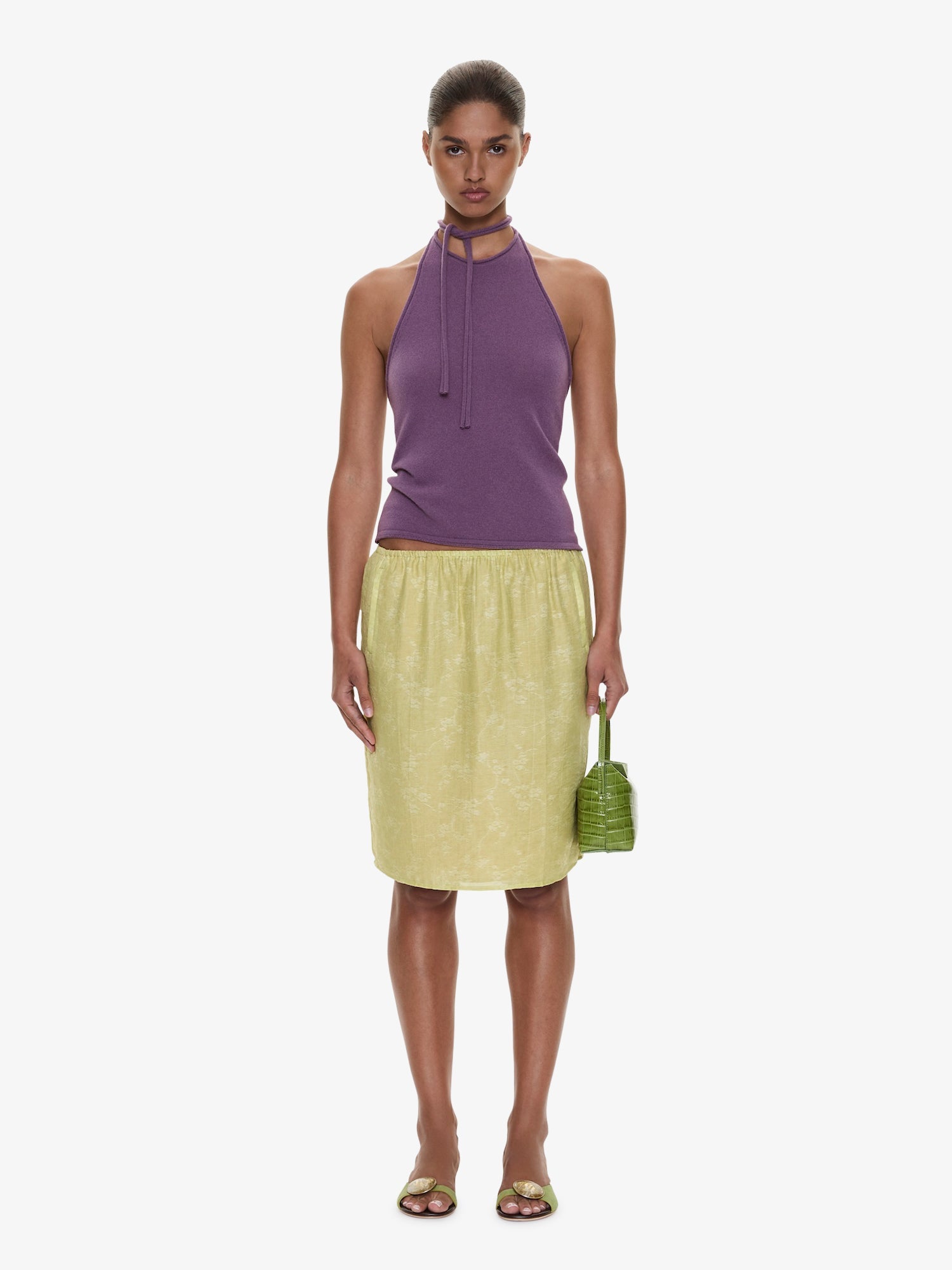 Image of a model wearing Skirts. Product name - Light Leak Jacquard Slip Skirt in Chartreuse colour by brand - CHRISTOPHER ESBER