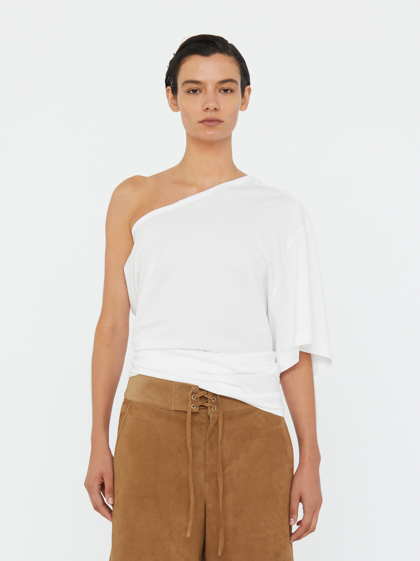 Image of a model wearing Tops. Productname: Christopher Esber One Shoulder Draped Tee in White colour by brand - Christopher Esber