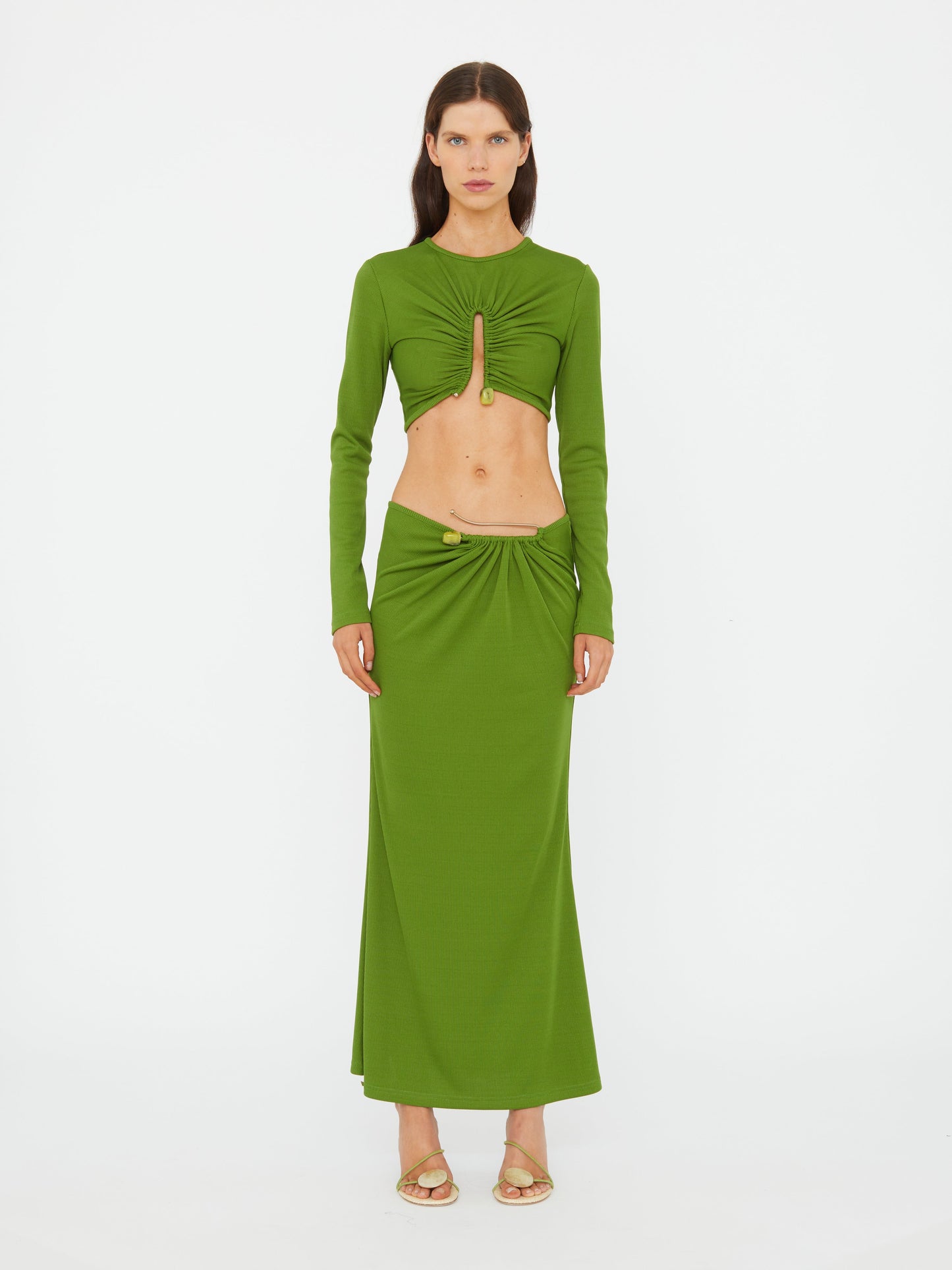 Image of a model wearing Skirts. Product name - Crystal Pin Rib Skirt in Cactus colour by brand - CHRISTOPHER ESBER