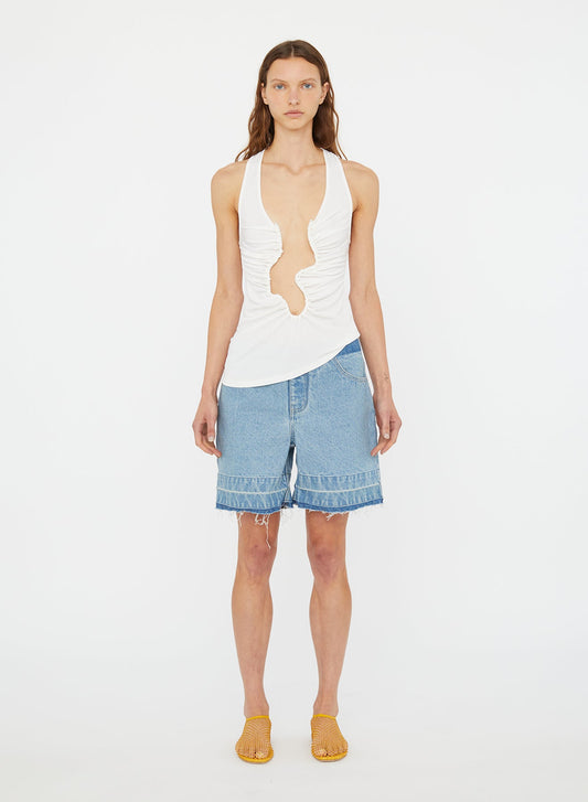 Image of a model wearing Shorts. Product name - Deconstruct Denim Short in Indigo colour by brand - Christopher Esber