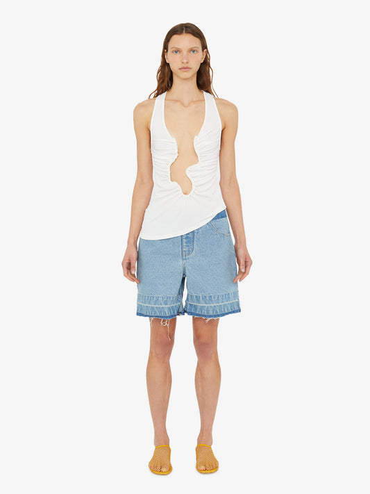 Image of a model wearing Shorts. Product name - Deconstruct Denim Short in Indigo colour by brand - Christopher Esber