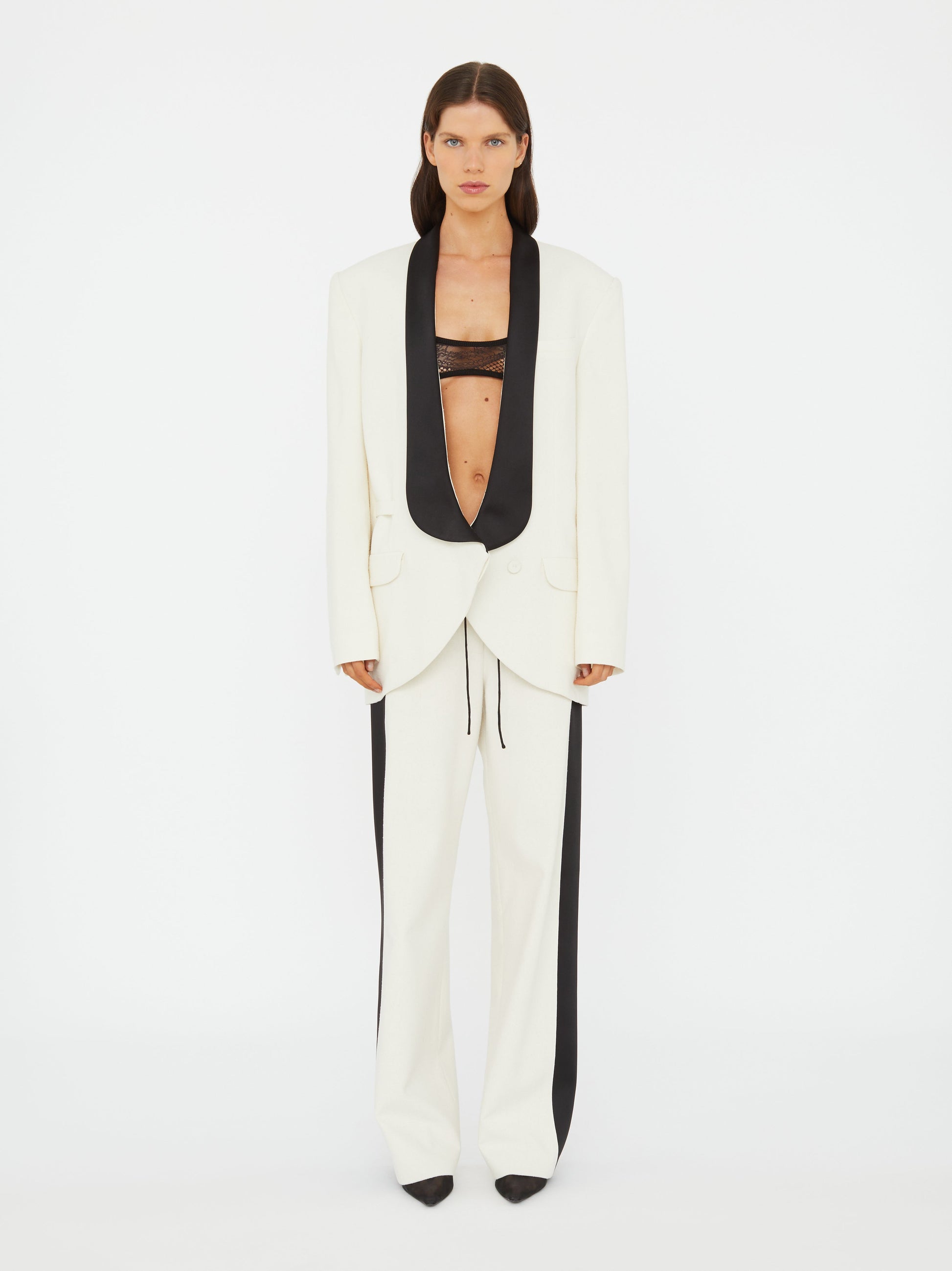 Image of a model wearing Outerwear. Productname: Christopher Esber Tuxedo Contrast Silk Blazer in Black colour by brand - Christopher Esber