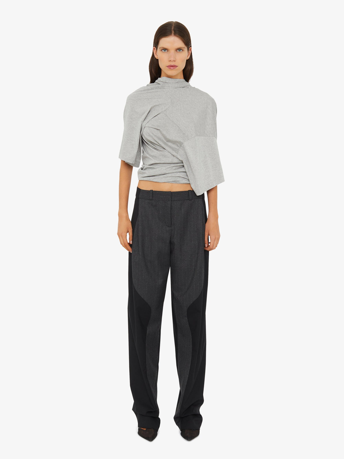 Image of a model wearing Pants. Product name - Torrent Pinstripe Trouser in Stripe colour by brand - Christopher Esber
