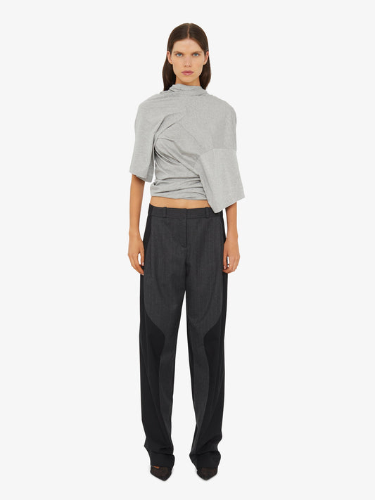 Image of a model wearing Pants. Product name - Torrent Pinstripe Trouser in Stripe colour by brand - Christopher Esber