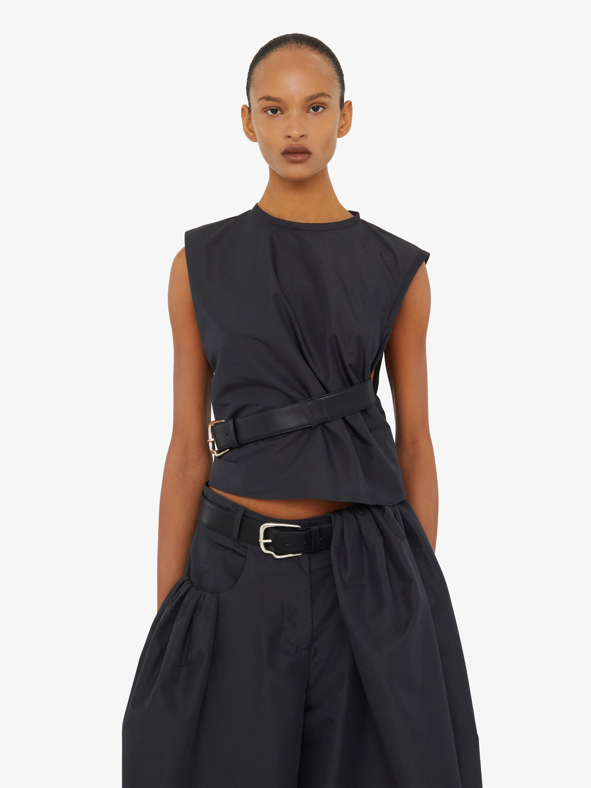 Image of a model wearing Tops. Product name - Locus Belted Taffeta Tank in Carbon colour by brand - CHRISTOPHER ESBER