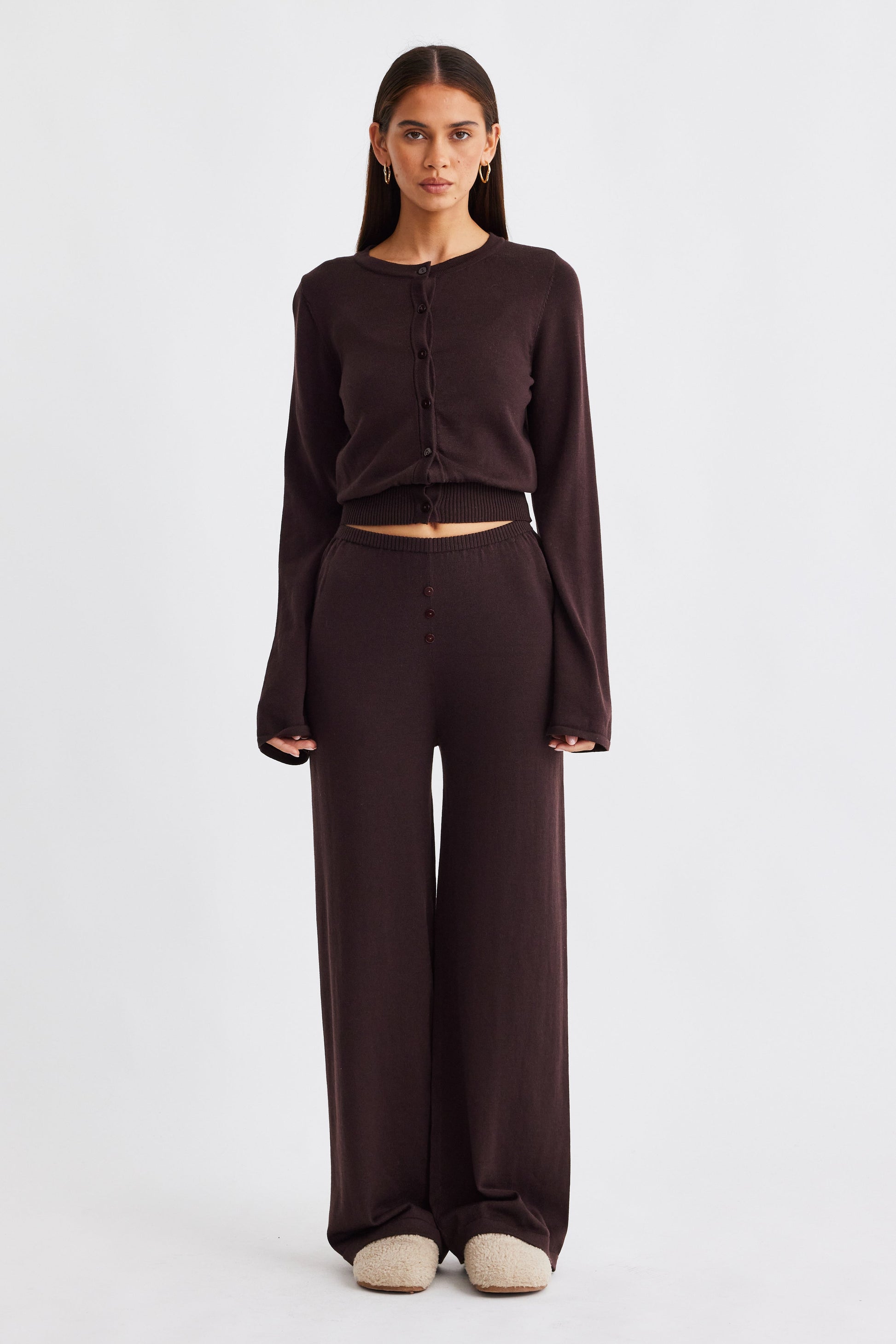 Image of a model wearing Pants. Productname: SNDYS AUGUST BUTTON PANTS in Chocolate colour by brand - SNDYS