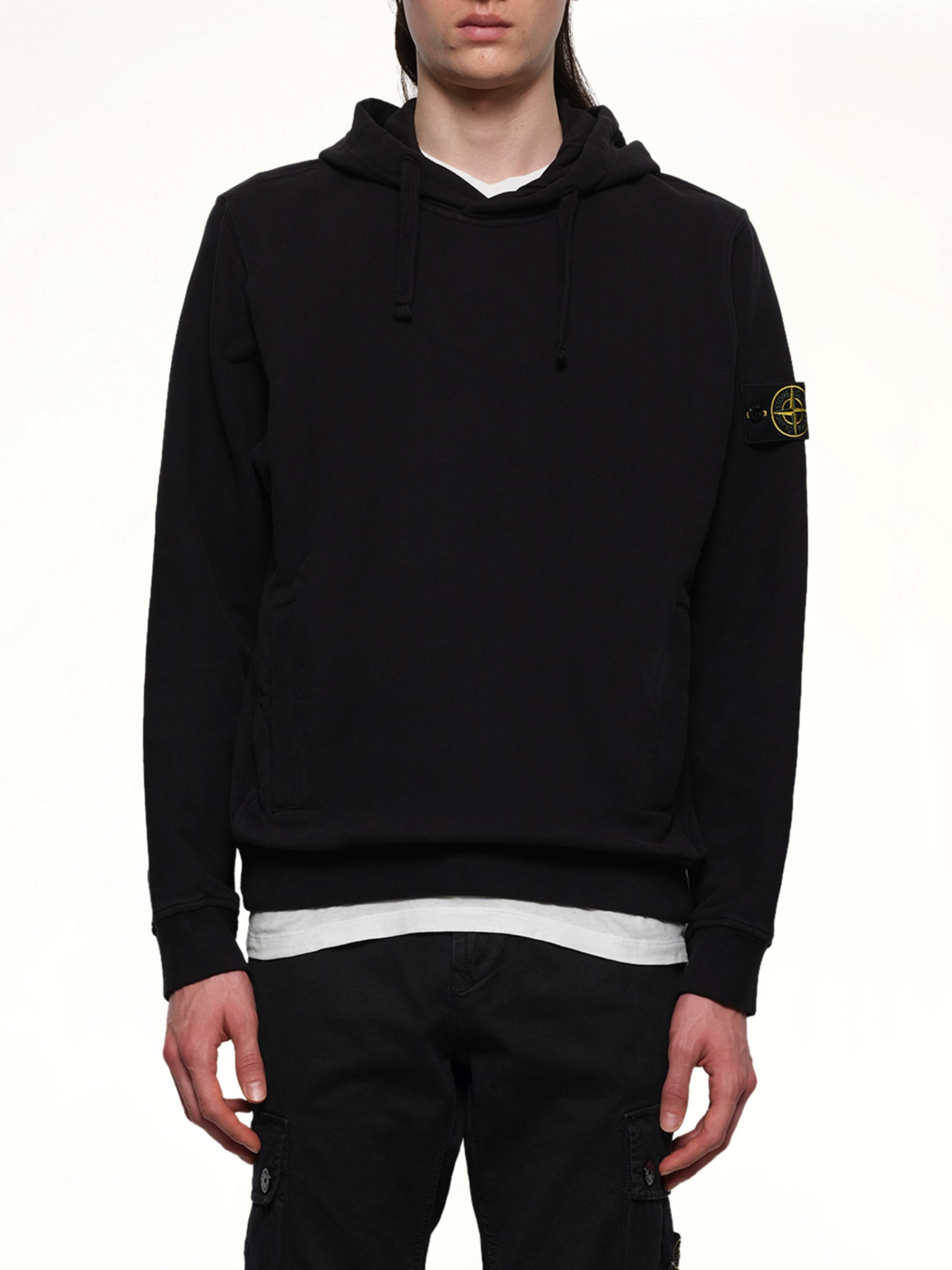 Image of a model wearing Outerwear. Product name - 6100029 Cotton Fleece Hoodie in Black colour by brand - STONE ISLAND