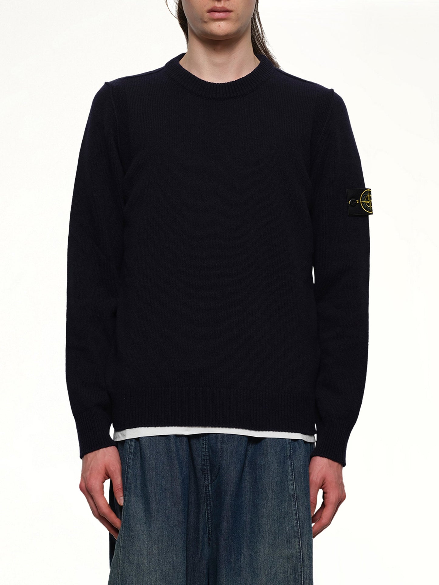 Image of a model wearing Outerwear. Product name - 510007 Crewneck Sweater in Navy colour by brand - STONE ISLAND