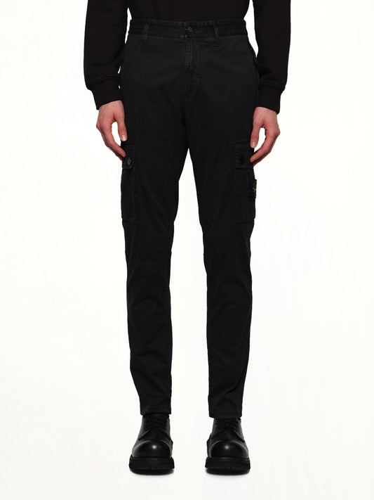 Image of a model wearing Pants. Product name - 3100034 Stretch Organic Broken Twill Cotton 'Old' Effect Cargo Pants in Black colour by brand - STONE ISLAND