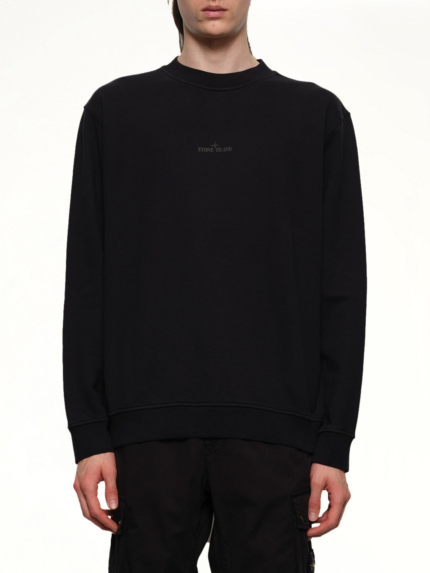 Image of a model wearing Outerwear. Product name - 610001 Industrial Four Sweatshirt in Black colour by brand - STONE ISLAND