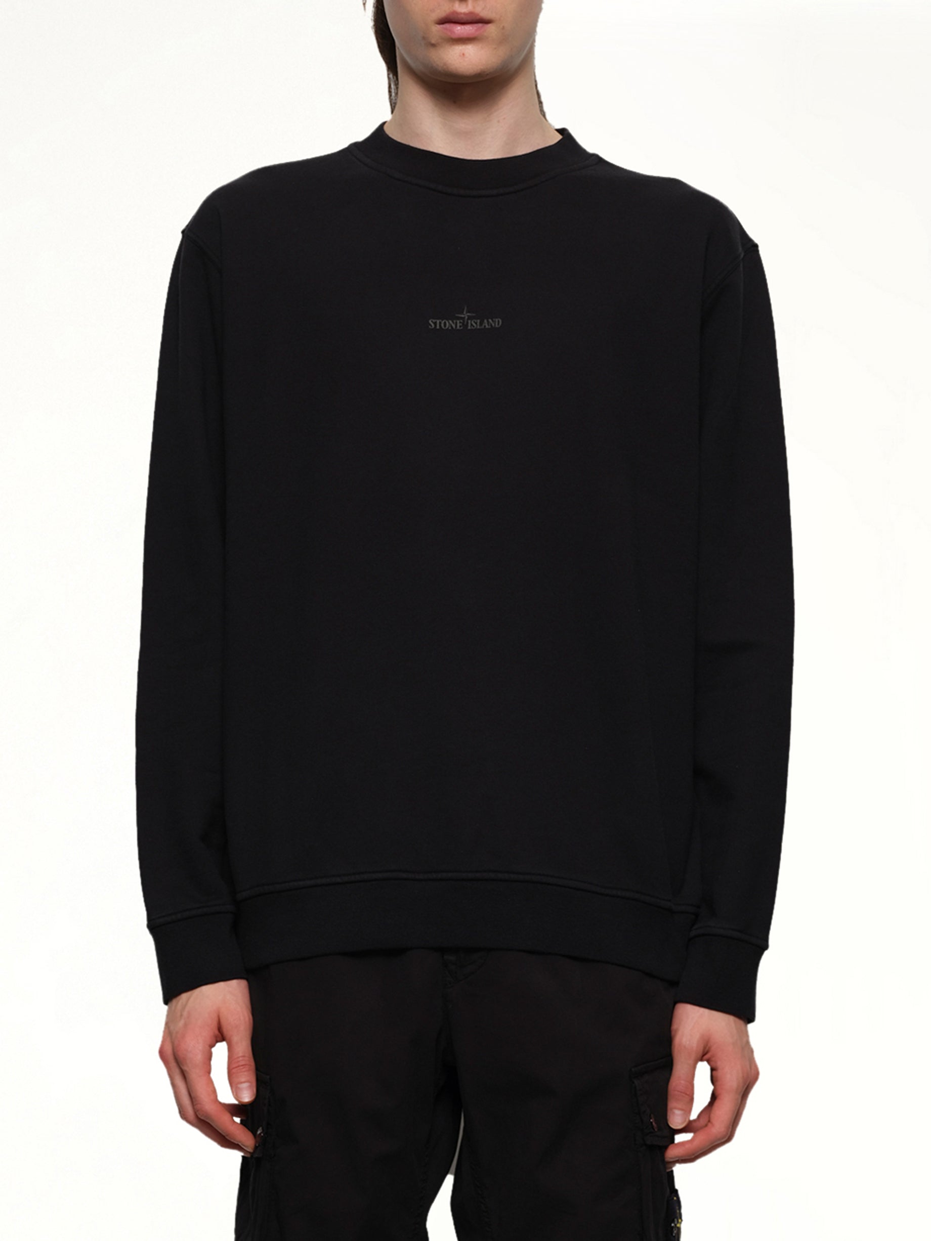 Image of a model wearing Outerwear. Product name - 610001 Industrial Four Sweatshirt in Black colour by brand - STONE ISLAND
