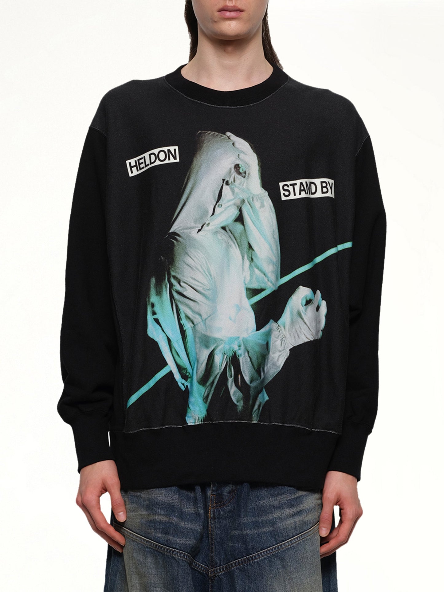 Image of a model wearing Tops. Productname: UNDERCOVER Heldon Stand By L/S T-Shirt in BLACK colour by brand - UNDERCOVER