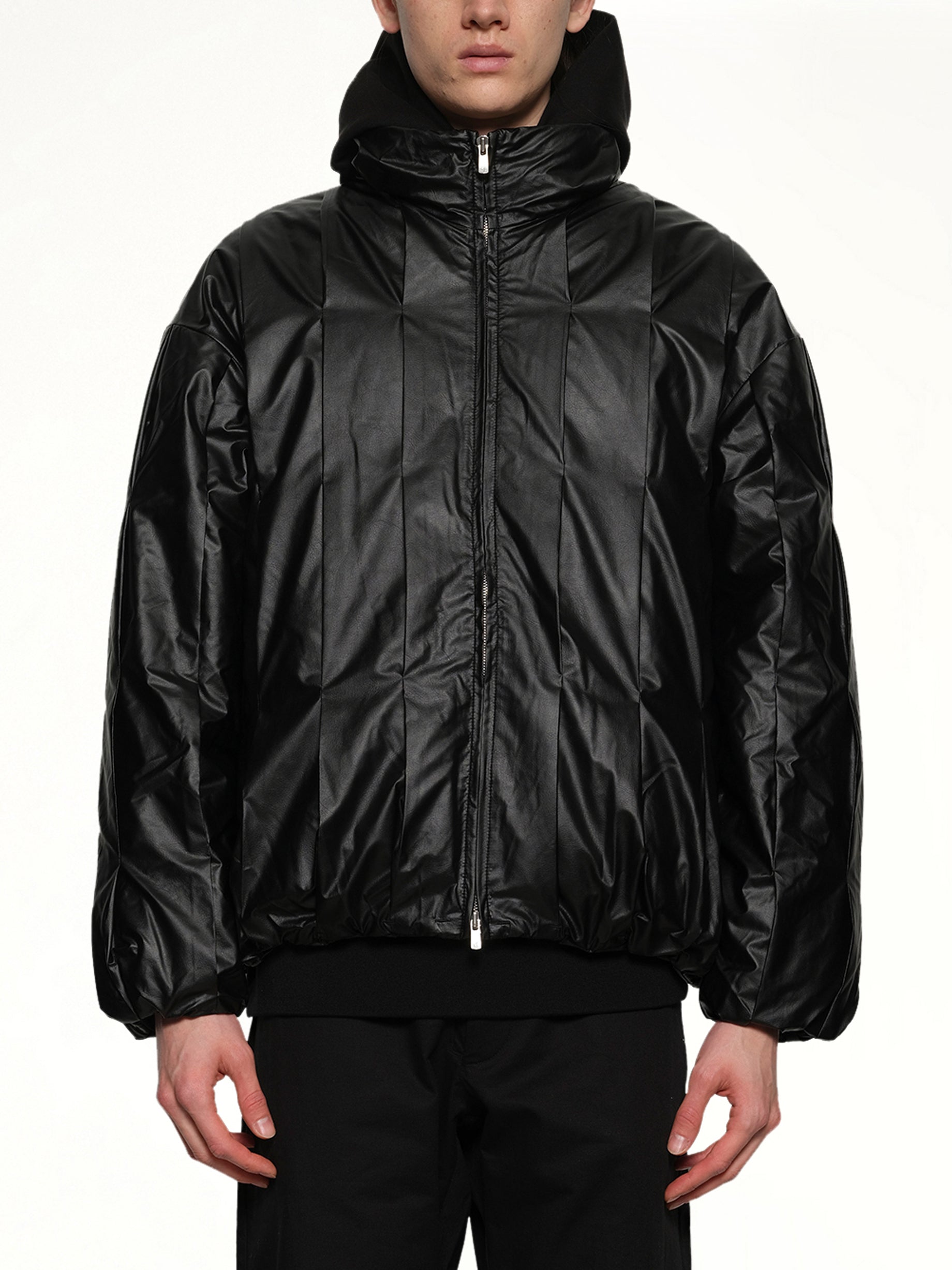 Image of a model wearing Outerwear. Productname: POST ARCHIVE FACTION Cocoon Down Jacket in Metallic Black colour by brand - POST ARCHIVE FACTION