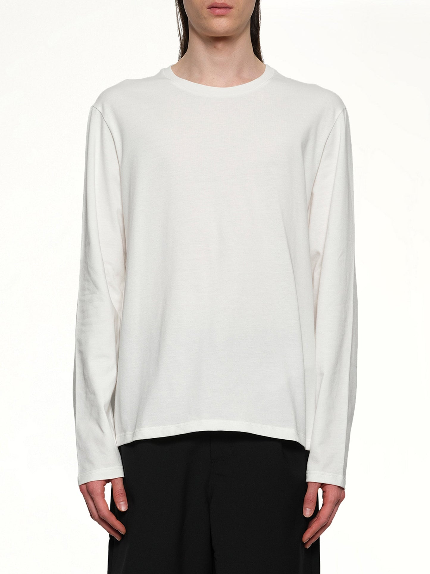 Image of a model wearing Tops. Productname: JIL SANDER Leather Patch Long Sleeve T-Shirt in PORCELAIN colour by brand - JIL SANDER
