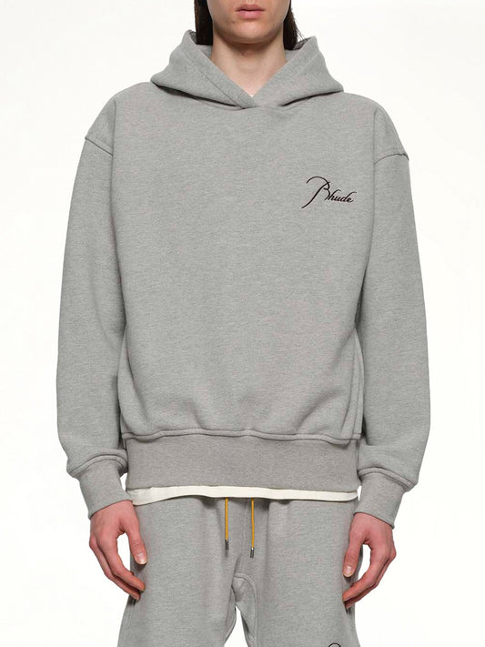 Image of a model wearing Outerwear. Productname: RHUDE Classique Side Zip Pullover Hoodie in HEATHER GREY/BLACK colour by brand - RHUDE