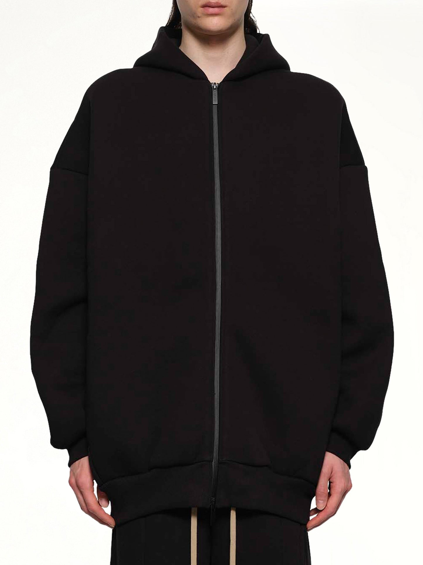 Image of a model wearing Outerwear. Product name - Zip Hoodie in Black colour by brand - FEAR OF GOD