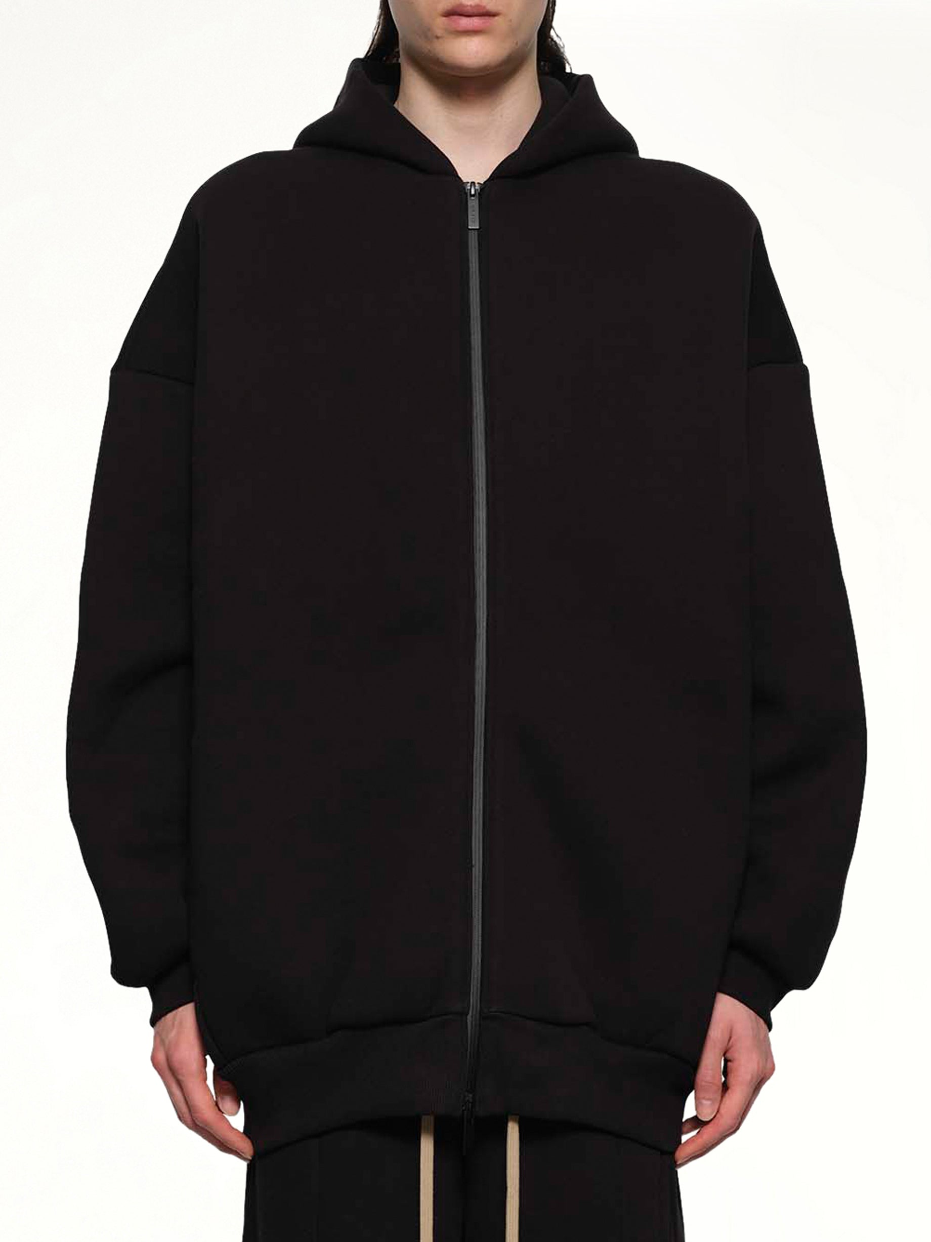 Image of a model wearing Outerwear. Product name - Zip Hoodie in Black colour by brand - FEAR OF GOD